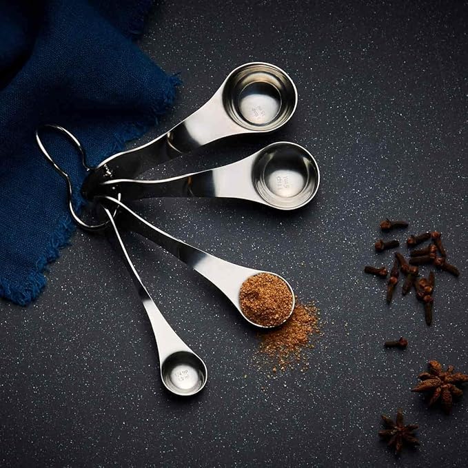 Nambé Alvaro Uribe Measuring Spoon Set – 4 Stainless Steel Spoons with Artistic Twisted Handles, Metric & Standard Markings, Rust-Resistant Easy-Clean Utensils for Cooking & Baking Precision