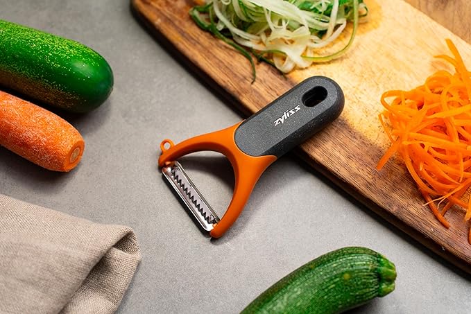 Zyliss Julienne Y Peeler – Ultra-Sharp Stainless Steel Blade for Carrots, Zucchini & Potatoes – Ergonomic Wheatstraw Grip – Built-in Eye Cutter & Safety Cover – Dishwasher Safe – Orange